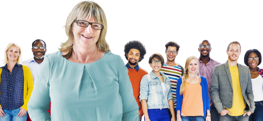 Diverse group of people / members standing behind an individual lady wearing glassess and smiling.