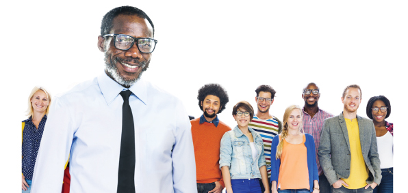 Diverse group of people / members standing behind a man smiling and wearing glasses.