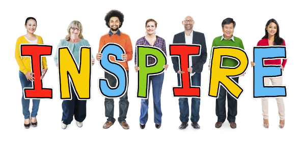 Group of 7 youth care professionals each holding a cut-out letter that spell inspire.